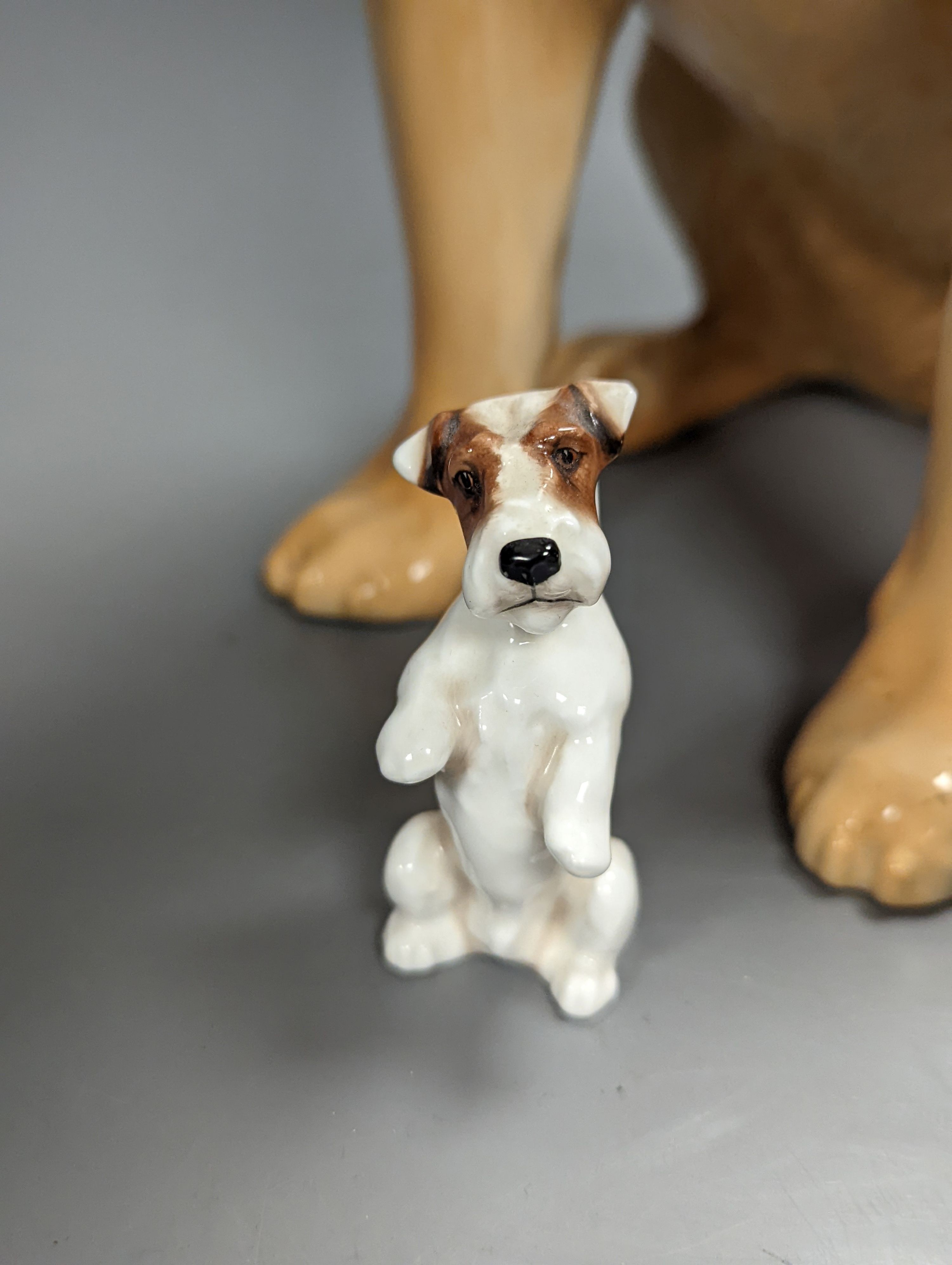 A Royal Doulton figure of a seated Labrador (No. 2314), height 34cm, a small Beswick Airedale Terrier and another (3)